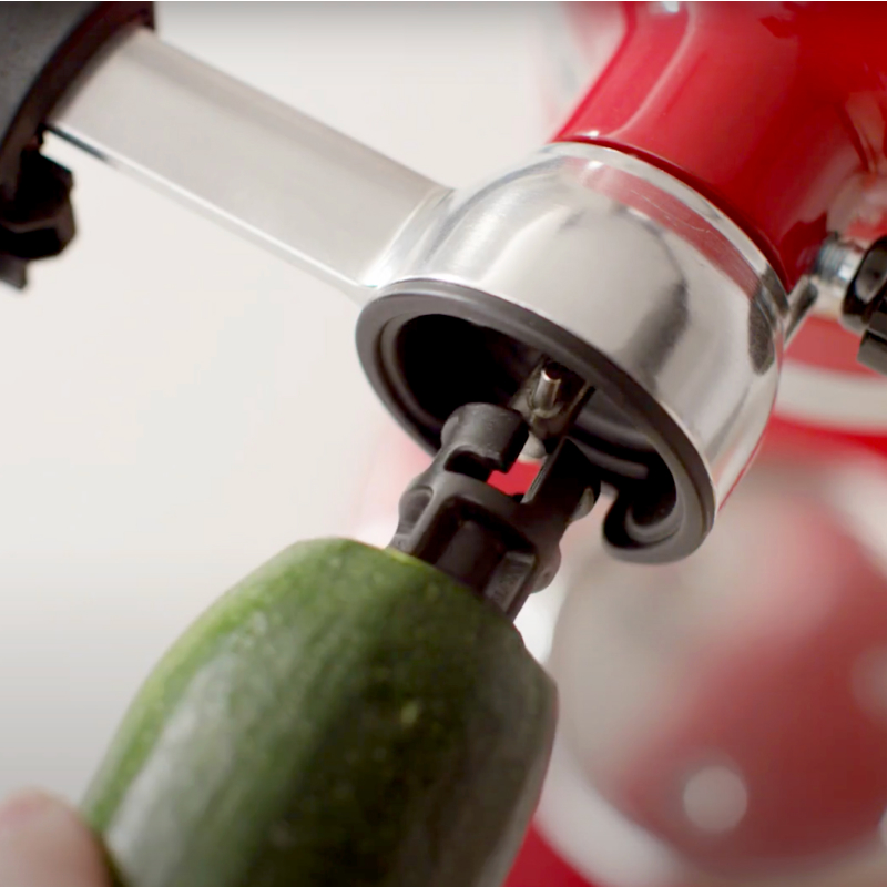 Zucchini inserting into the Vegetable Sheet Cutter food holder