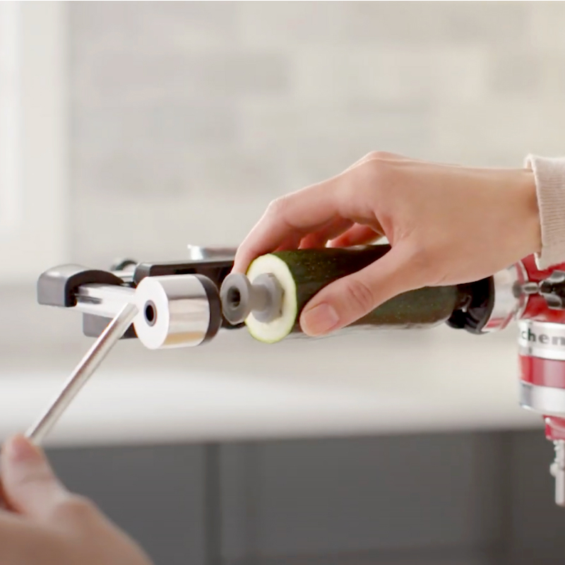 Zucchini being secured in a KitchenAid® Vegetable Sheet Cutter Attachment