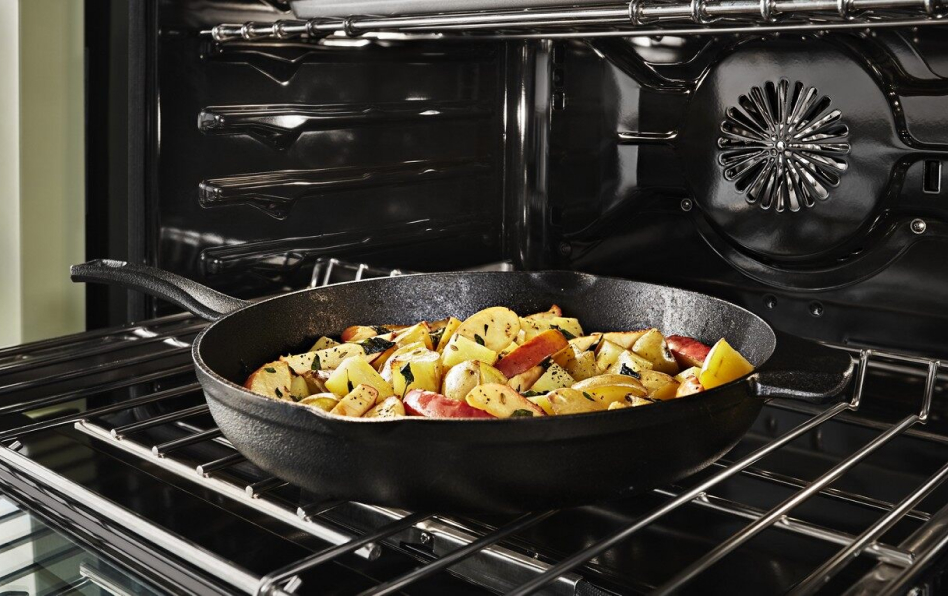 Roasted potatoes in a skillet in an open convection oven