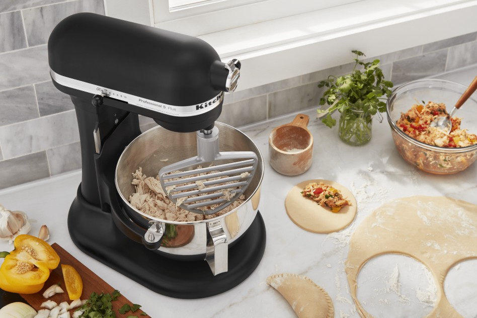 Stand mixer shredding meat for empanada pastries