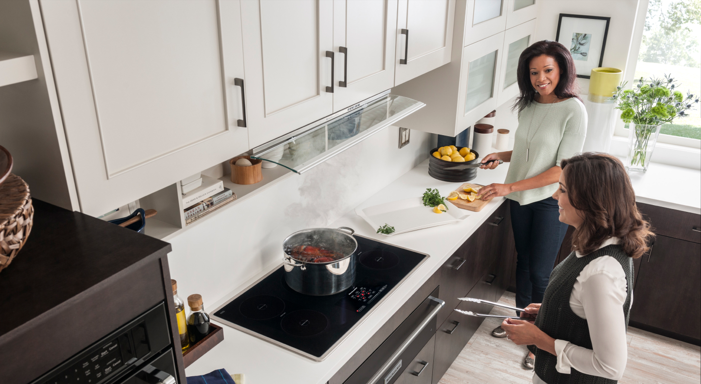 Two people cooking in a kitchen