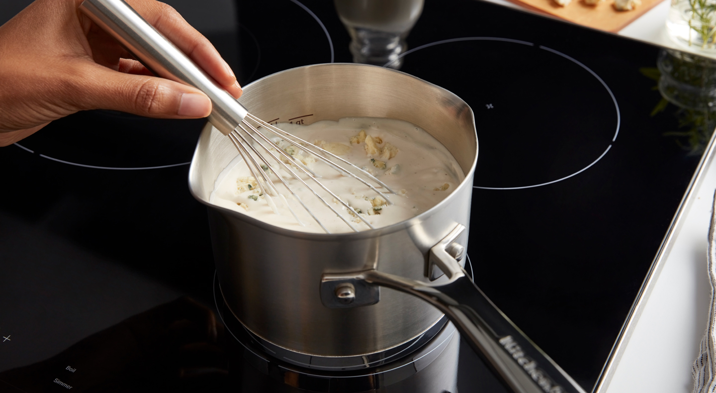 Person whisking a sauce