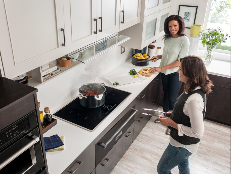 Two people cooking in a kitchen
