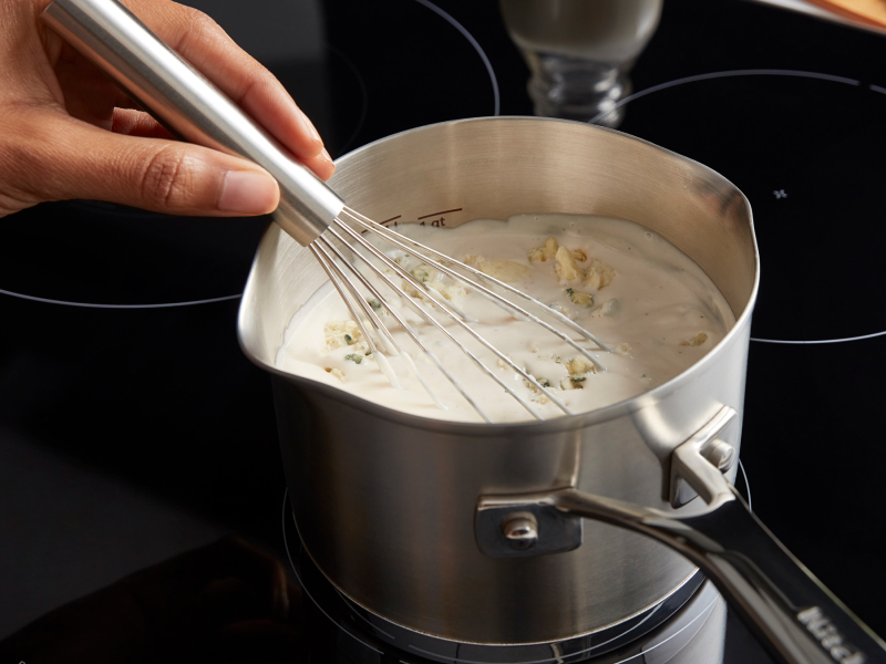 Person whisking a sauce
