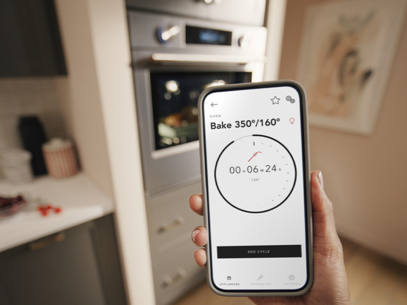 Person checking oven bake time on phone app