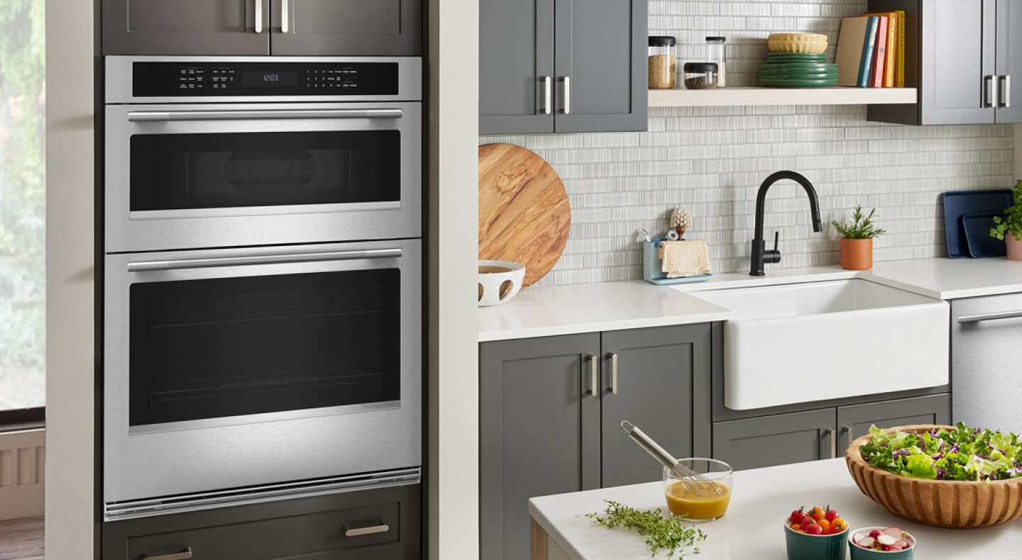 Stainless steel KitchenAid® combination wall oven in a modern kitchen