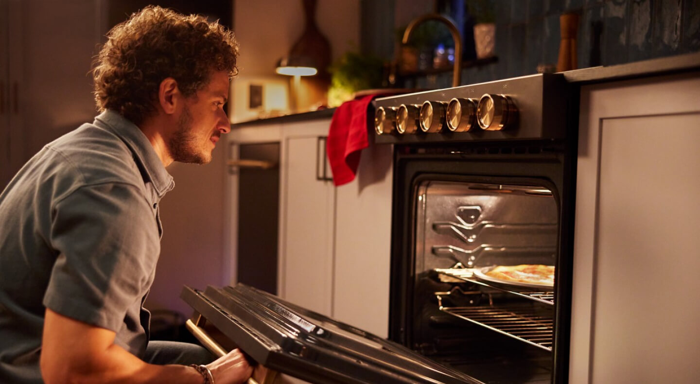Person opening an oven to check on food
