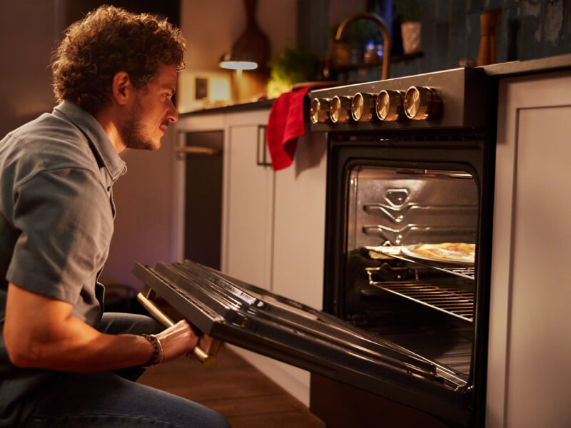 Person opening an oven to check on food