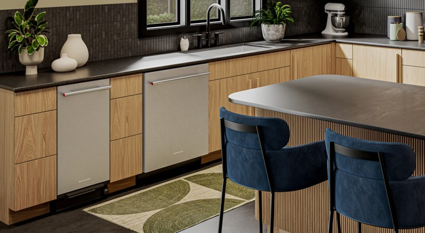 The inside of an eat-in kitchen with wooden cabinetry and a KitchenAid® trash compactor