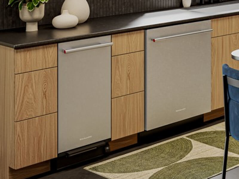 The inside of an eat-in kitchen with wooden cabinetry and a KitchenAid® trash compactor