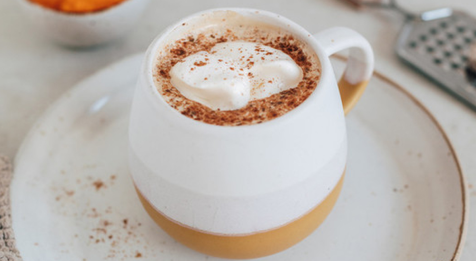 Whipped coffee in a mug on a tea plate