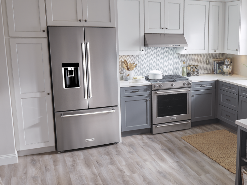 Stainless steel KitchenAid® french door refrigerator set in white cabinetry