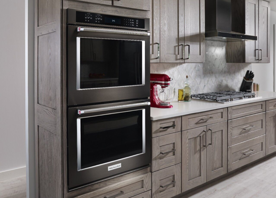 2 KitchenAid built-in wall ovens surrounded by gray cupboards