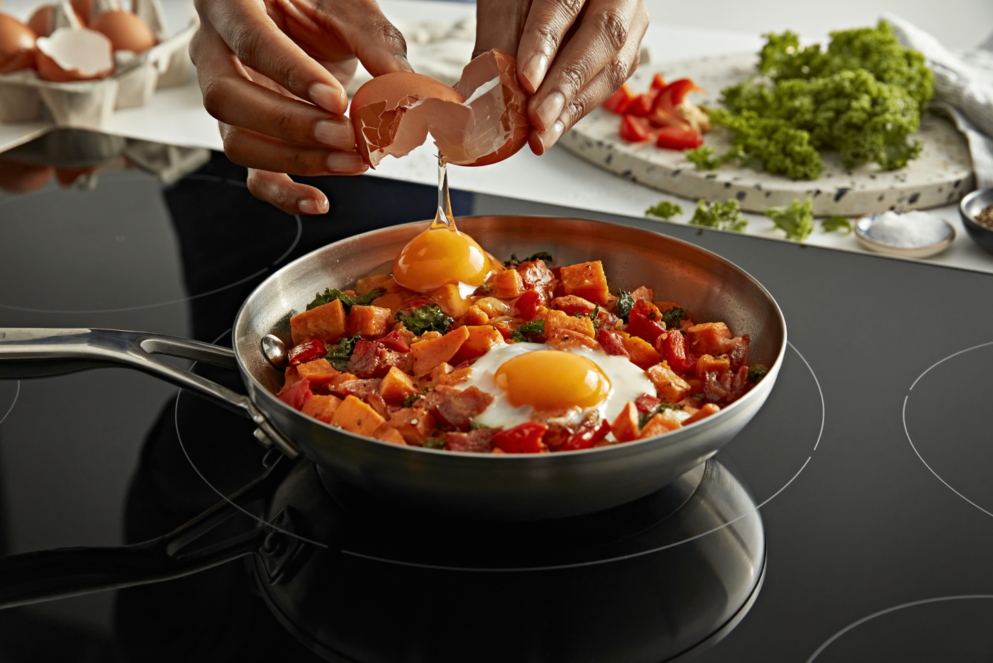 A person cracking an egg into a dish