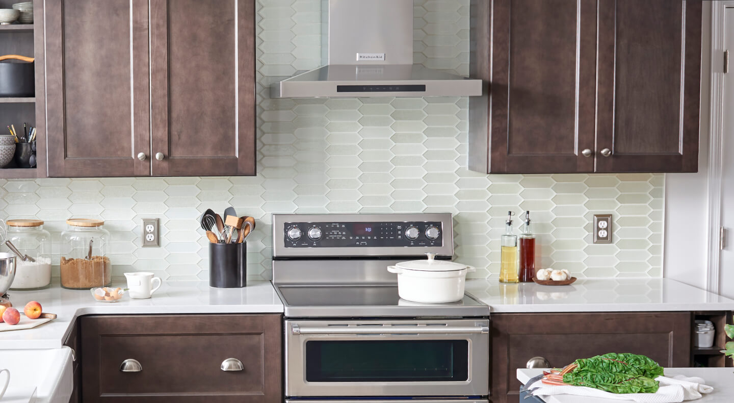 Wall-mount range hood over an electric range