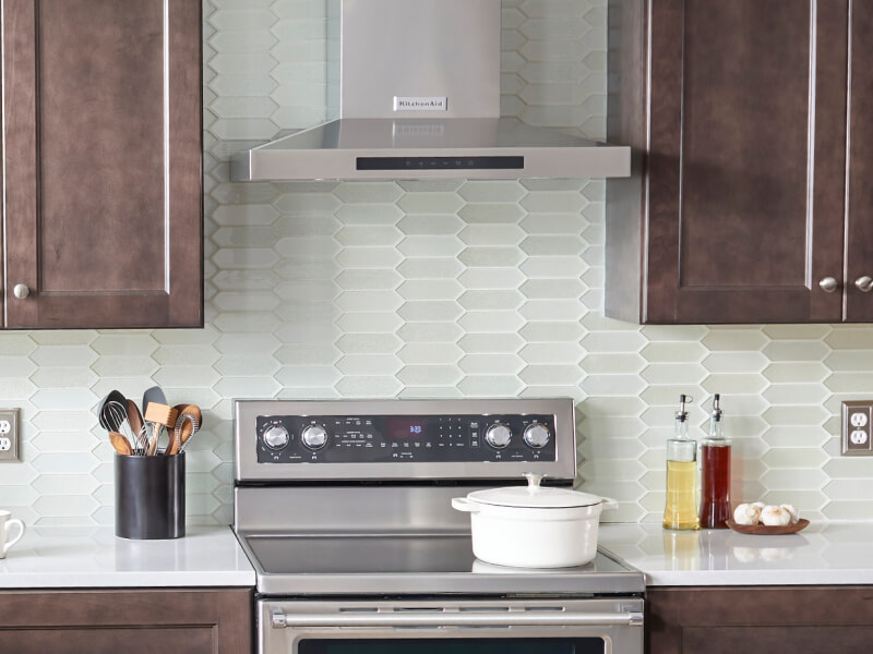 Wall-mount range hood over an electric range