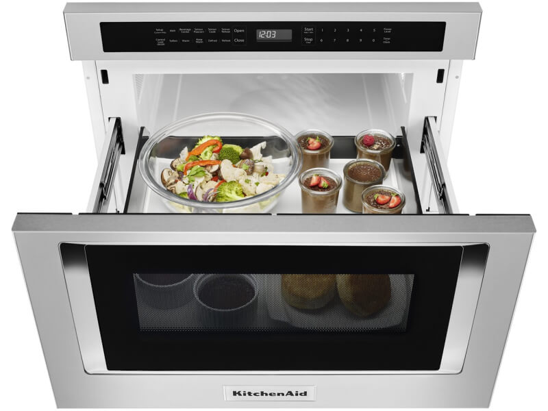 An open KitchenAid® undercounter microwave oven drawer with an assortment of food inside