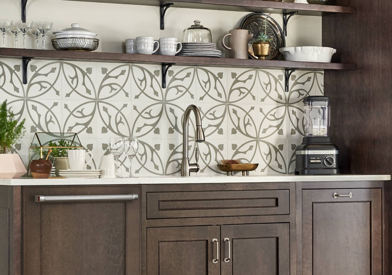A clean kitchen sink area with dark wood cabinetry