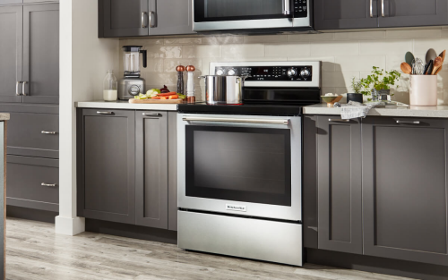 Stainless steel range in a kitchen with dark cabinets