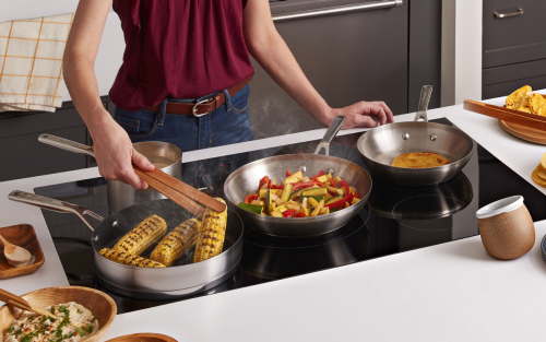 Multiple dishes cooking on a KitchenAid® induction cooktop