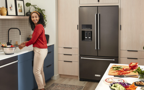 KitchenAid® French door refrigerator built into cream-colored cabinetry
