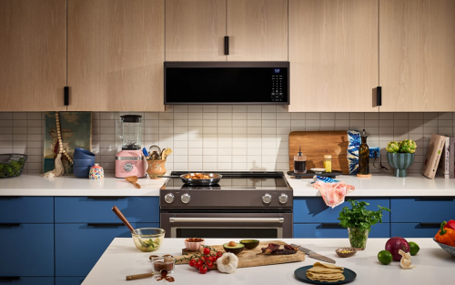 KitchenAid® over-the range microwave and electric range in brown and blue cabinetry