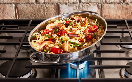 Pasta in a pan on a gas stove burner