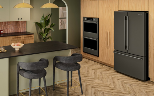 A kitchen with an island, wooden cabinetry, and a French door refrigerator