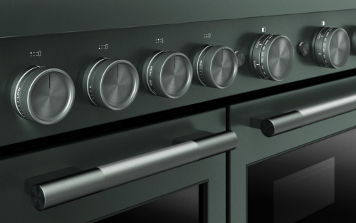 A close-up of the temperature dials on a commercial-style range
