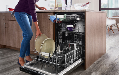 Person loading dishes into a dishwasher