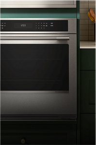 A single wall oven in a green contemporary kitchen.
