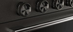 A close-up on the handle and knobs of a Black Ore range.