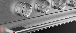 A close-up on the handles and knobs of a Stainless Steel range.