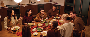 People gathering around the table at Room to Host