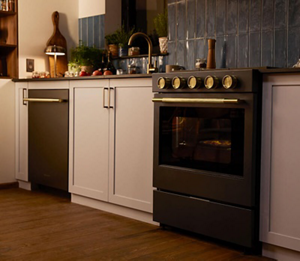 A KitchenAid® dishwasher and gas slide-in range nestled between white cabinets