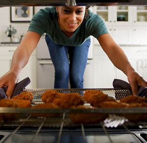 Person pulling food out of an oven