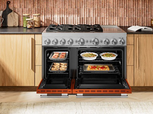 A commercial style double oven gas range with the doors open and food inside