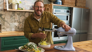 Homemade founder Joel Gamoran using the spiralizer attachment on a blue salt KitchenAid®️ stand mixer