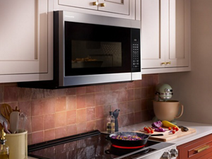 KitchenAid® over-the-range microwave above food cooking on the stovetop