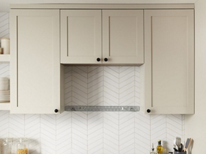 Opening below upper cabinetry for an over-the-range microwave or range hood