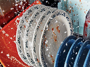 Dishes inside a dishwasher getting sprayed with water