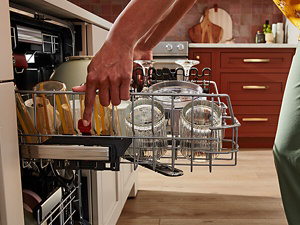 Person pulling out a dishwasher rack